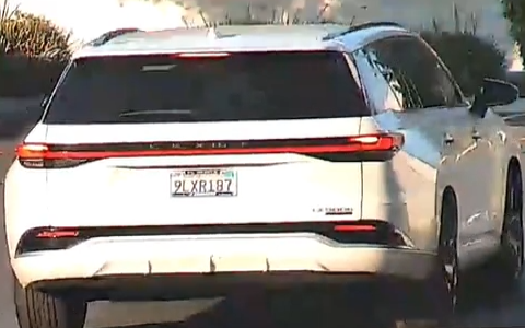 White SUV, plate 9LXR187
